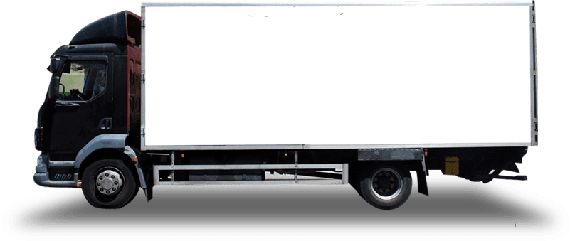 A white truck is parked in the dark.