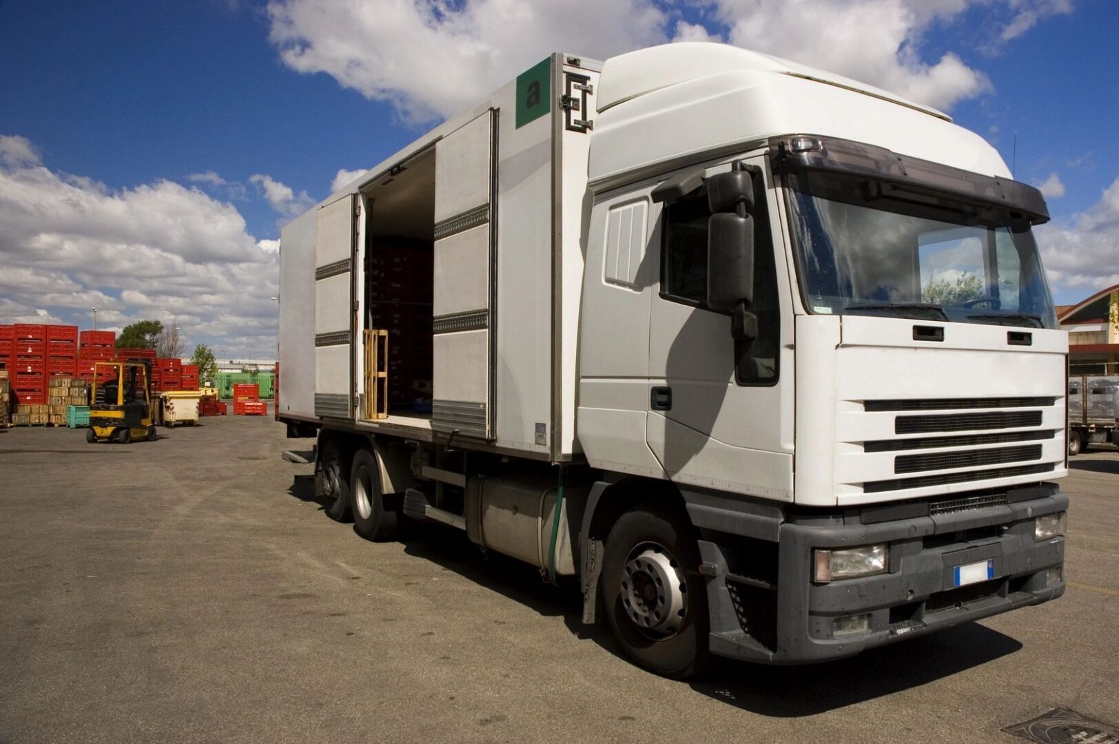 A white truck parked on the side of a road.
