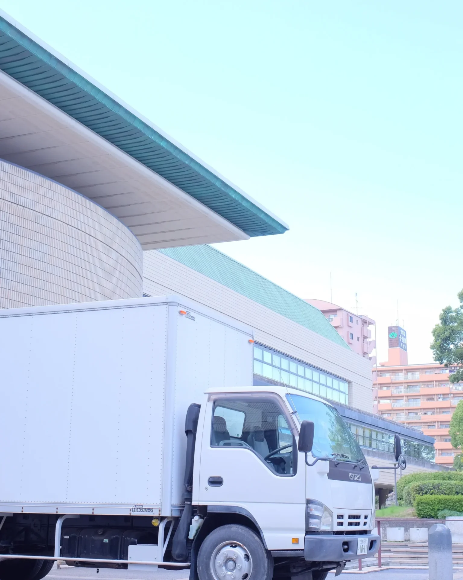 A white truck parked in front of a building.